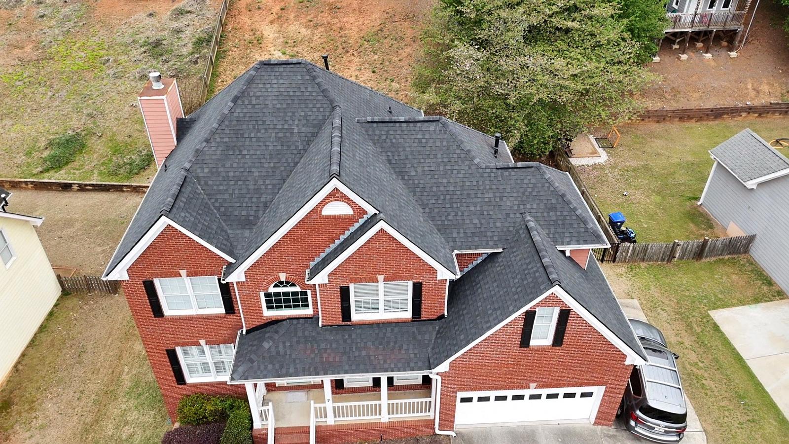 Finished architectural shingle roof on a two-story brick home